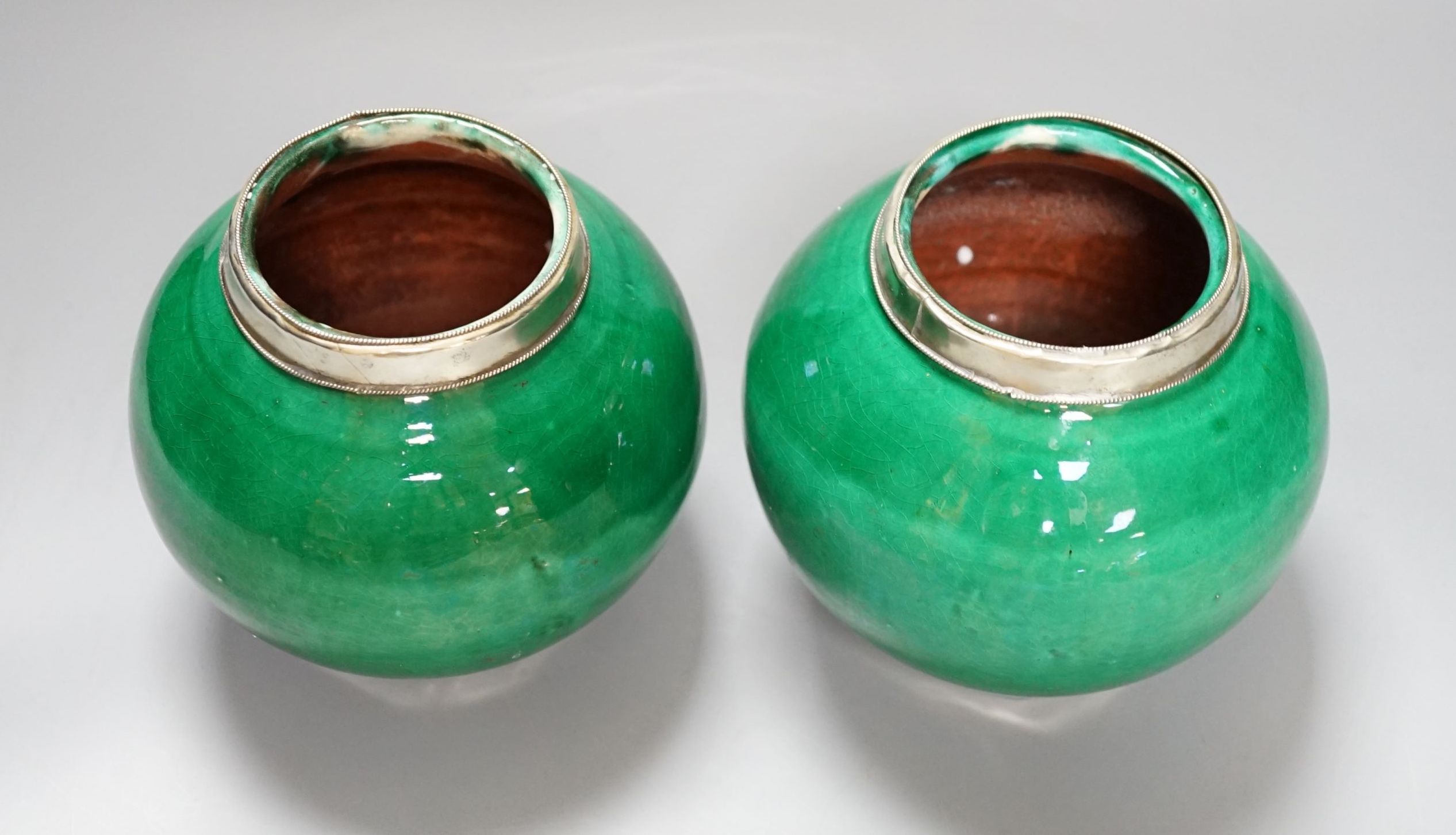 A pair of Tibetan green glazed vases - 14cm high